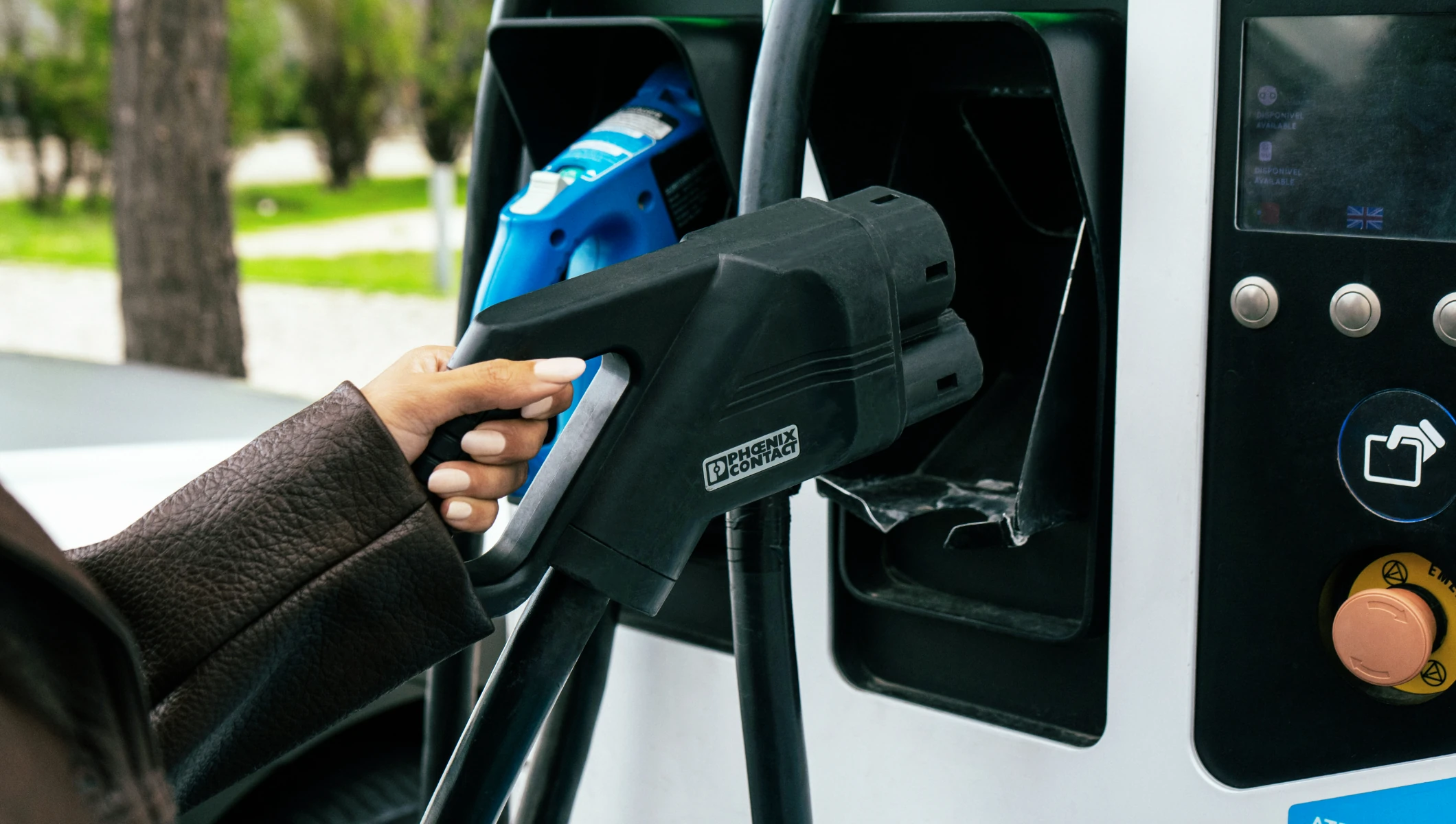 mão a pegar no manípulo de carregamento elétrico